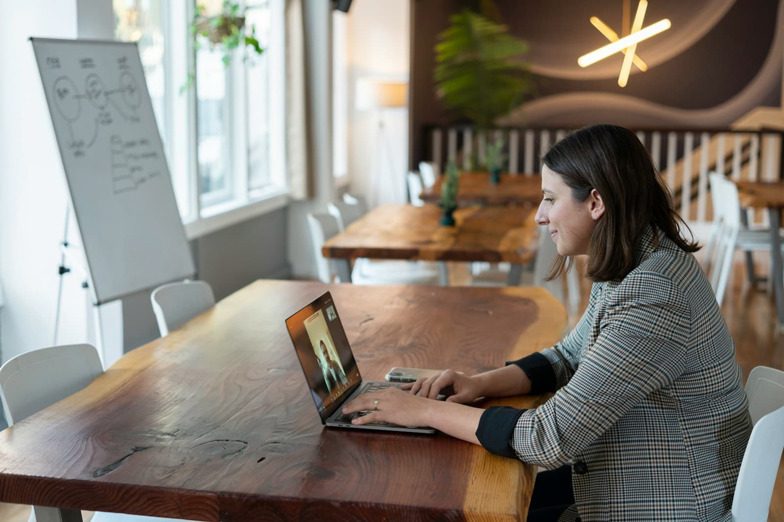 A therapist meeting a client over video from her laptop